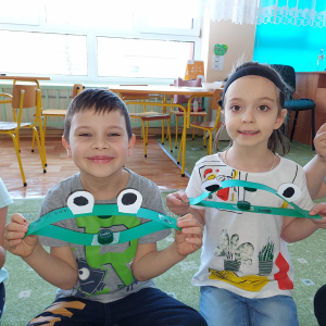 Dzieci wykonały żabki z kolorowych kartek i korków.