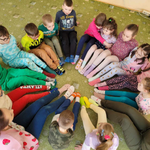 Dzieci z kolorowymi skarpetkami siedzą na dywanie