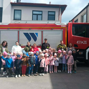 Zdjęcie grupowe dzieci z grupy Muchomorki i Jagódki na tle wozu strażackiego