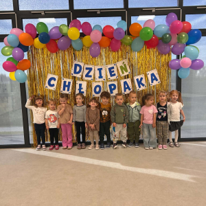 Zdjęcie grupowe dzieci. W tle dekoracja i balony.