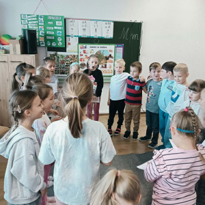 Dzieci stoją w kole. 